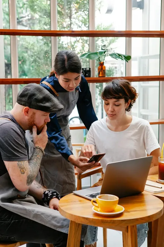 Server taking an order at the table from a phone